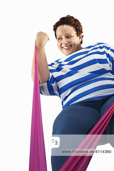 Large woman using resistance band