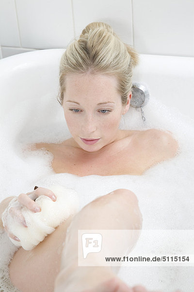 Woman washing in bubble bath