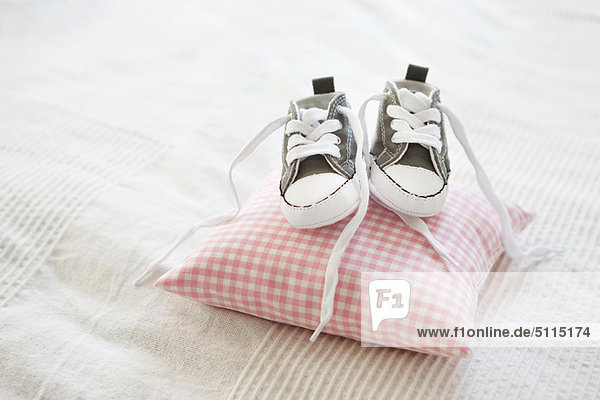 Baby shoes on pillow