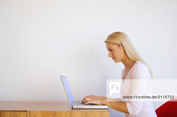 Woman using laptop at desk