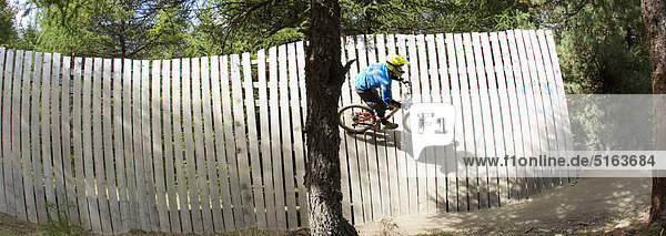 Italy  Livigno  View of man wall riding mountain bike at bikepark