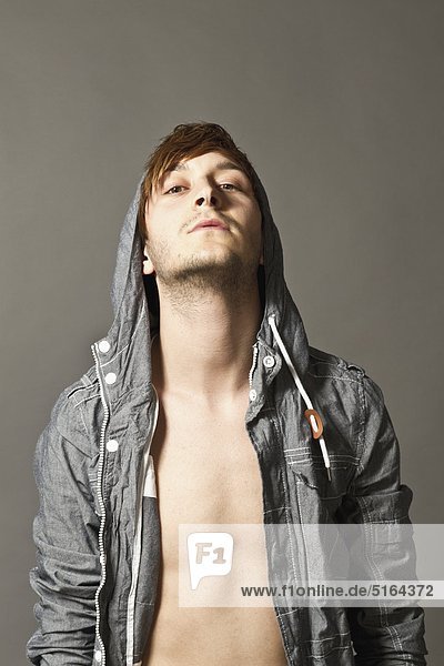 Close up of fashionable young man against grey background  portrait