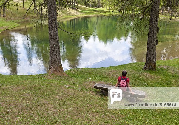 Woman resting at the Lago Scin near Cortina d’Ampezzo Italy