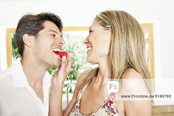 Frau füttert Freund Erdbeere