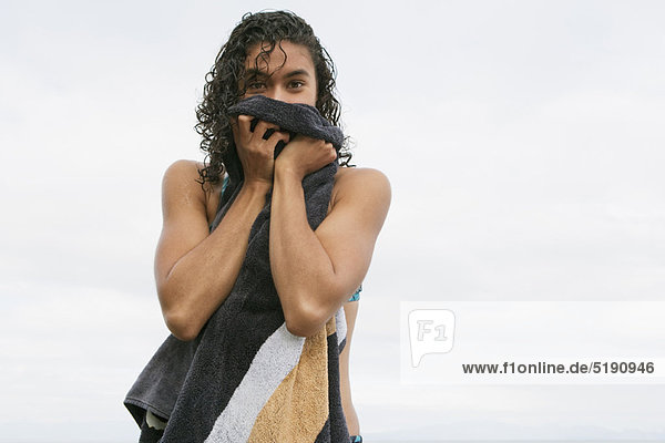 Woman toweling off on beach