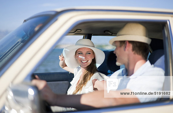 Newlywed couple riding in car