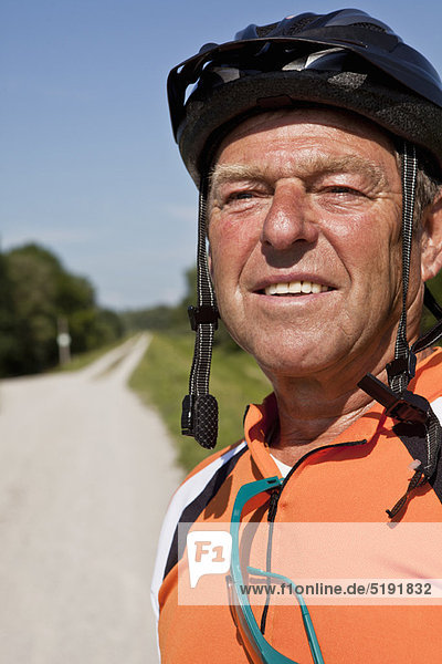 Older man wearing bike helmet