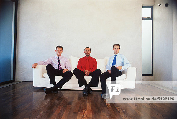 Businessmen sitting on couch in office
