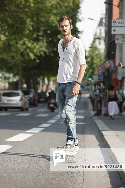 Man skateboarding on the road  Paris  Ile-de-France  France