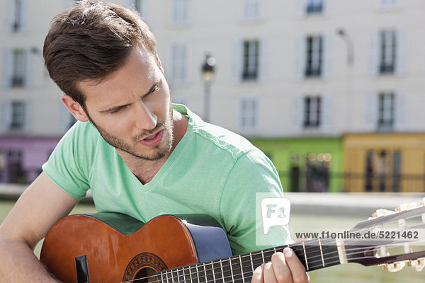 Man playing a guitar  Canal St Martin  Paris  Ile-de-France  France