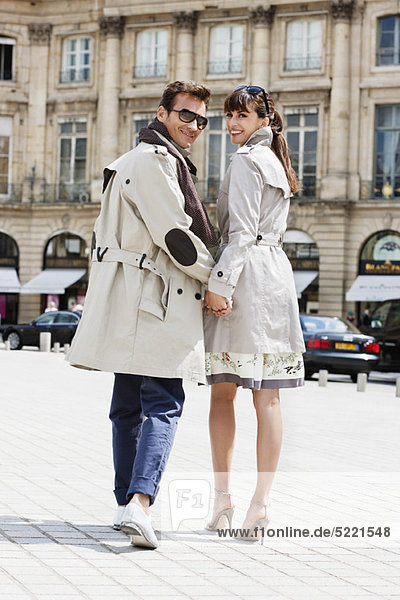 Couple walking on a street  Paris  Ile-de-France  France