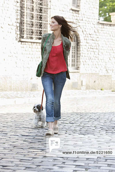 Woman holding a puppy on leash  Paris  Ile-de-France  France