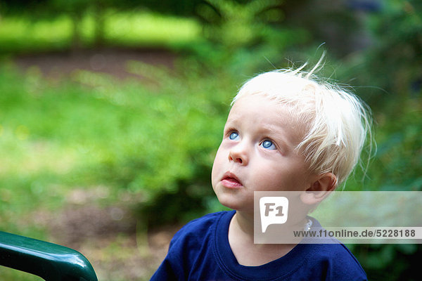 Blond toddler looking up