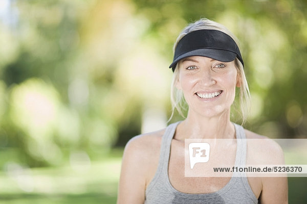 Smiling woman exercising outdoors
