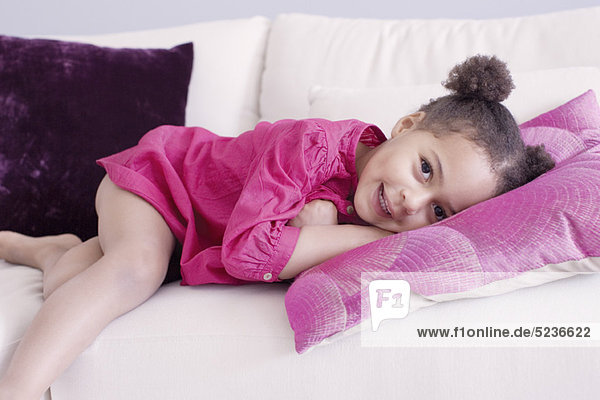 Little girl lying on couch