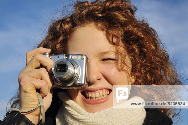 Woman taking a picture outdoors