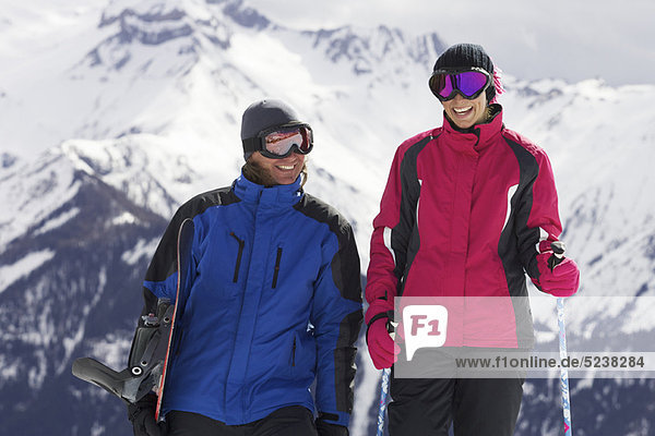 Paar mit Skistöcken am Berg