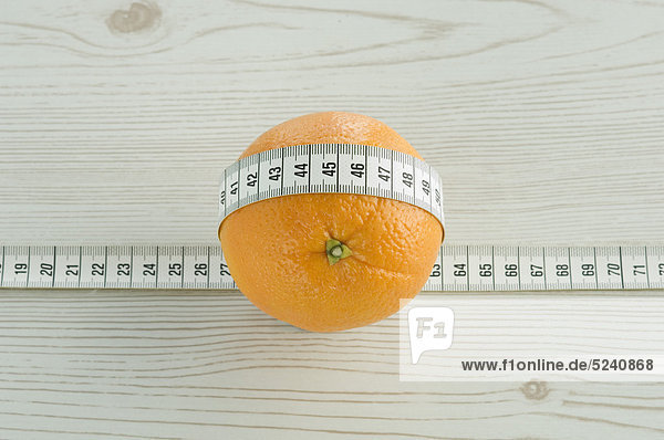 Orange wrapped round with measuring tape