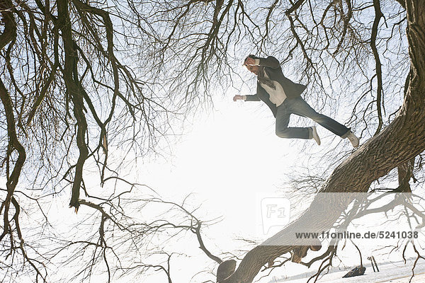 Man jumping from tree