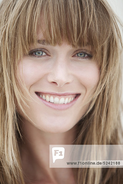 Close up of young woman with blonde hair  portrait  smiling