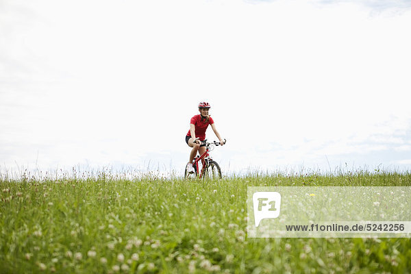 Young woman riding mountain bike