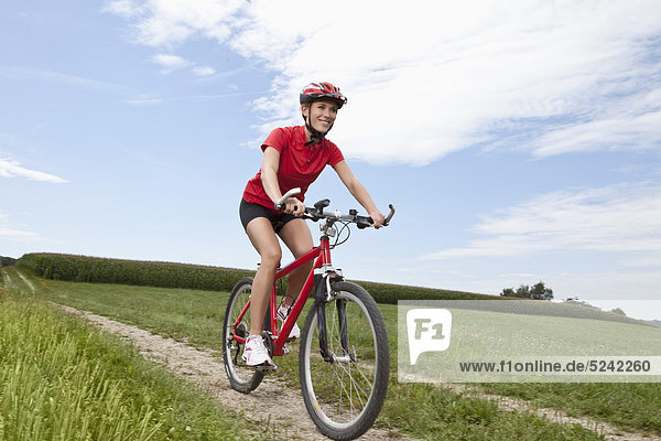 Young woman riding mountain bike