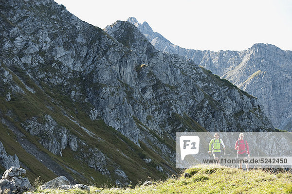 Austria  Kleinwalsertal  Man and woman hiking on mountain trail