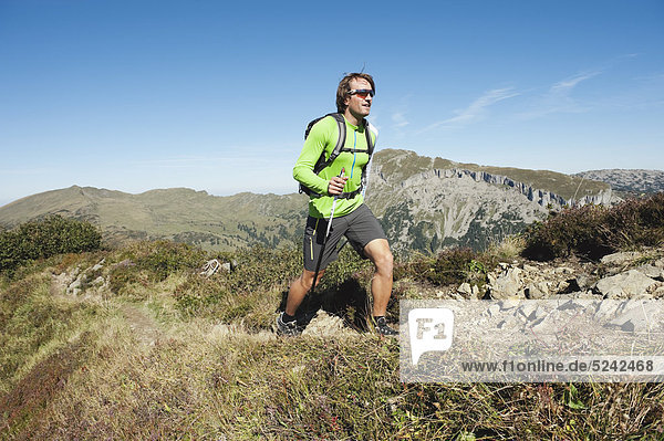 Austria  Kleinwalsertal  Mid adult man hiking on mountain trail