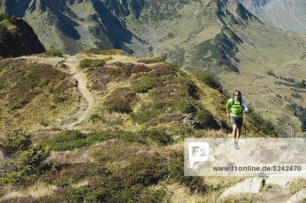 Austria  Kleinwalsertal  Mid adult man hiking on mountain trail