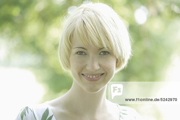 Close up of young woman in park  portrait  smiling