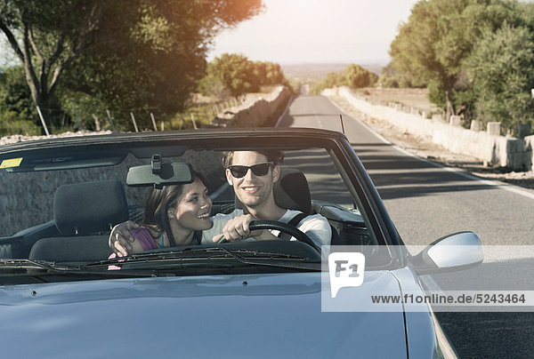 Spain  Majorca  Young couple travelling in cabriolet car