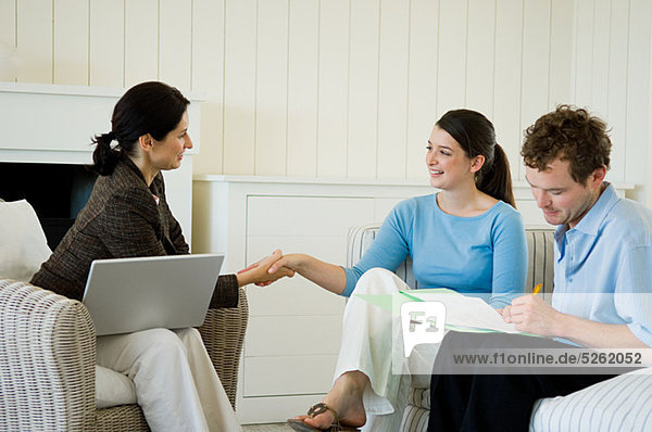Couple meeting financial advisor at home