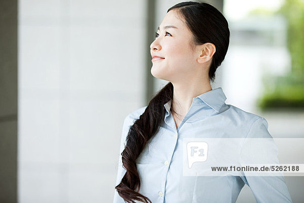 Portrait of young businesswoman looking away