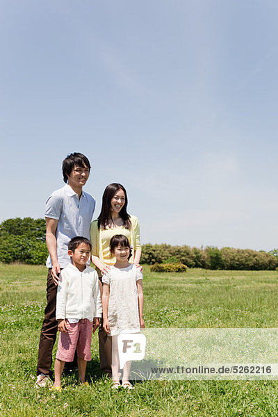 Family with two children in field  portrait