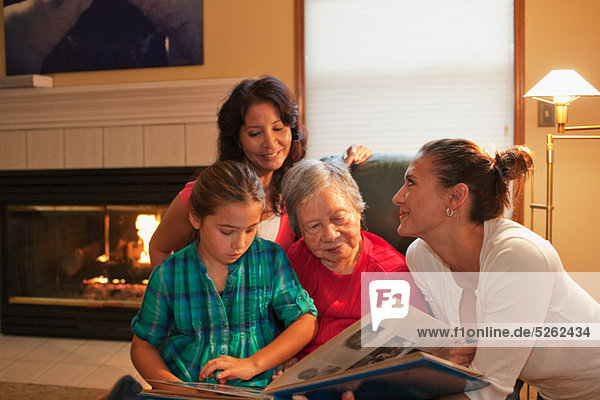 Three generation family looking at photo album