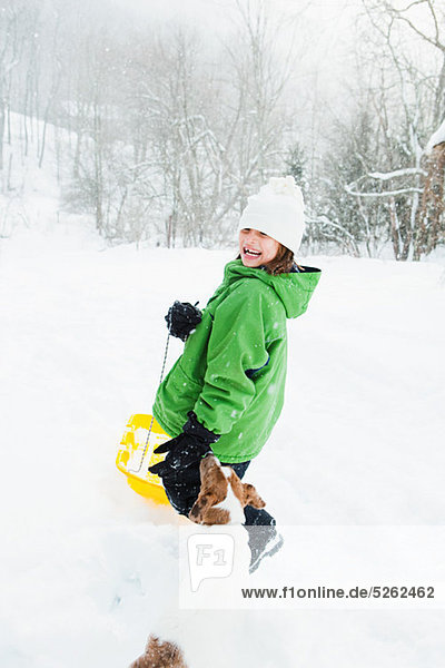 Girl sledging in snow