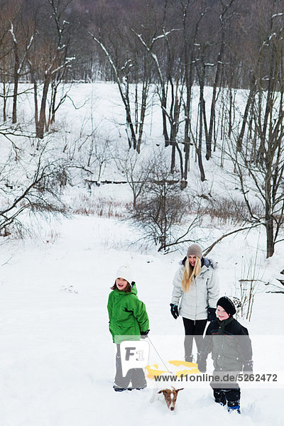 Family sledging in snow