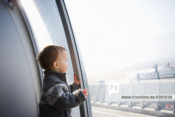 Junge  Blick durchs Fenster Flughafen