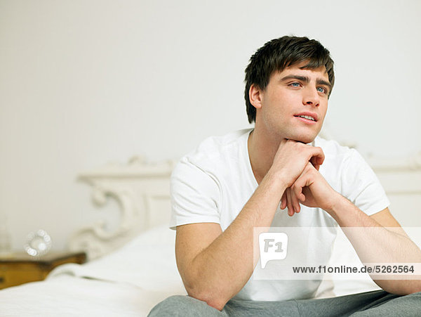 Young Man sitting on Bed  Porträt