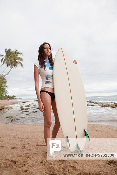Young Woman Holding Surfbrett  portrait