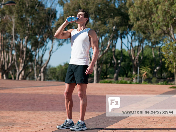 Young man drinking mineral water
