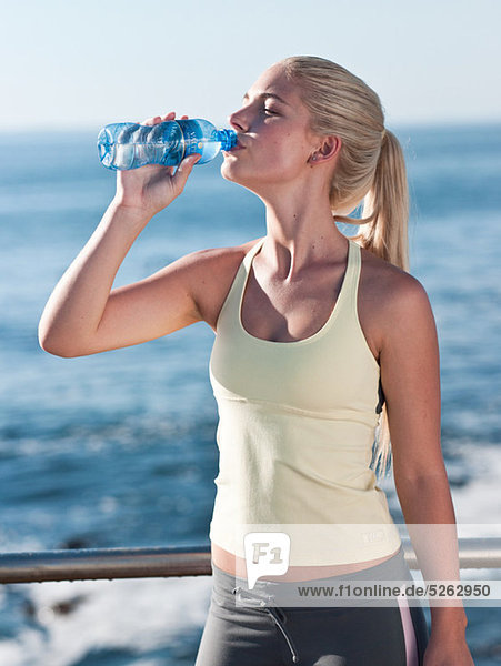 Junge Frau trinkt Mineralwasser