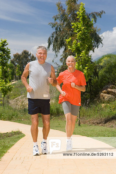 Mature couple jogging together
