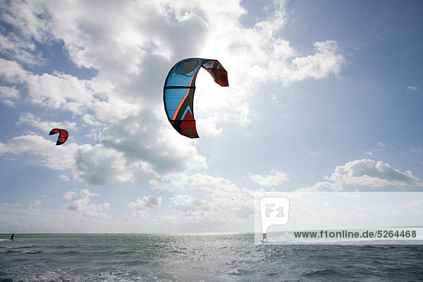Young man kitesurfing