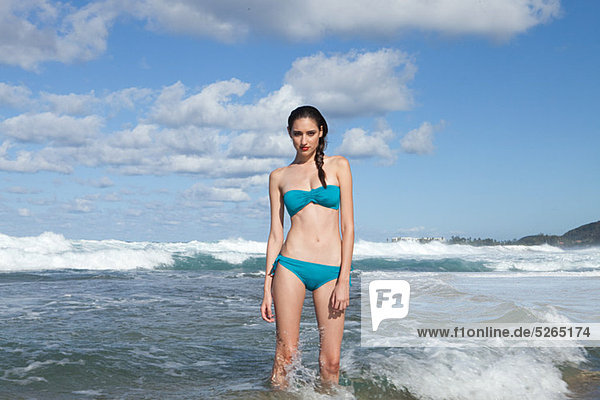 Woman wearing bikini standing in sea