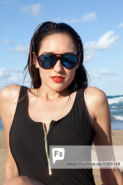 Woman on beach wearing sunglasses