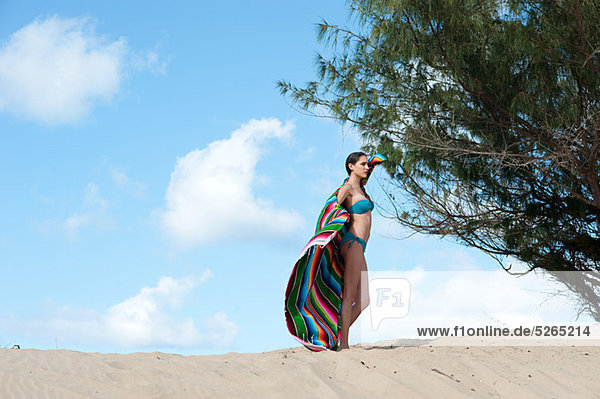 Woman standing on sand dune