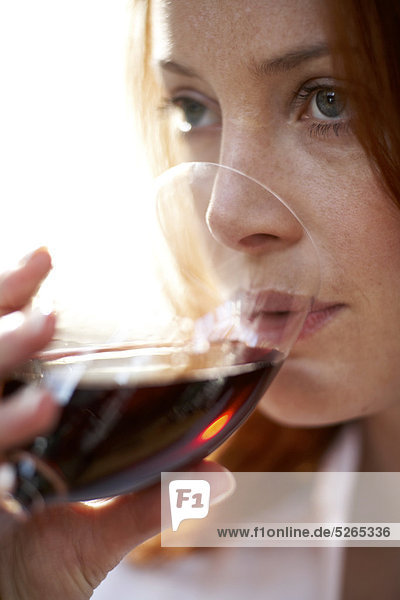 Close up of Mädchen mit rotem Haar trinken Rotwein