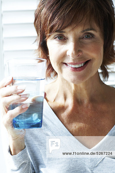 Porträt der Frau mit einem Glas Wasser