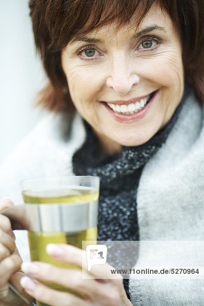 Reife Frau Kräuter Tee trinken